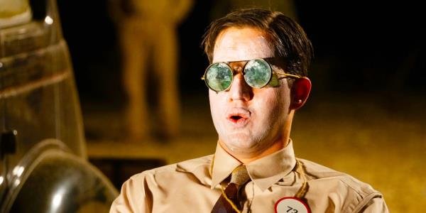 Benny Safdie wearing dark goggles, his face smeared in sunscreen, as he readies for the Trinity test in Nolan's Oppenheimer