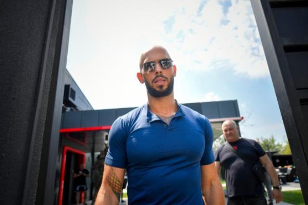 Andrew Tate exits his house after being released from house arrest and put under judicial co<em></em>ntrol measures, on the outskirts of Bucharest, Romania, Friday, Aug. 4, 2023. Andrew Tate, the divisive internet influencer who is charged in Romania with rape, human trafficking, and forming a criminal gang to sexually exploit women, won an appeal on Friday alo<em></em>ngside his brother to be released from house arrest and will instead be put under judicial co<em></em>ntrol measures, his spokesperson said. (AP Photo/Alexandru Dobre)