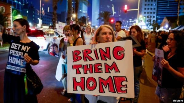 A woman holds a sign during a demo<em></em>nstration by family members and supporters of hostages who are being held in Gaza by Hamas gunmen, in Tel Aviv, Israel, Oct. 28, 2023.