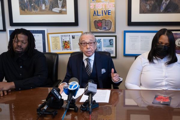 Laquana Badger Godfrey and stepfather Do<em></em>nnell Godfrey and their lawyer.