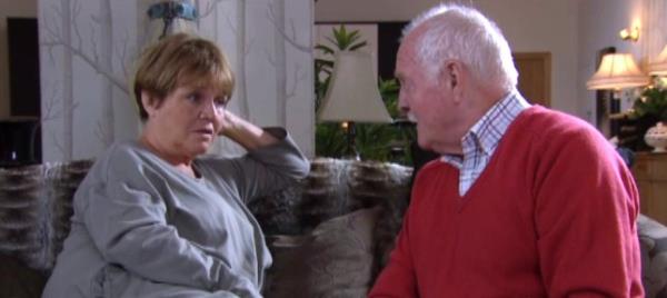 Brenda and Eric talk on the sofa in Emmerdale