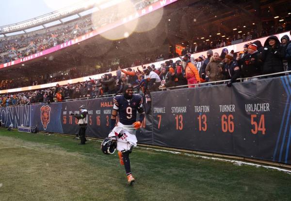 Bears safety Jaquan Brisker celebrates with fans as he walks off the field following the Week 17 win at Soldier Field on Dec. 31, 2023.