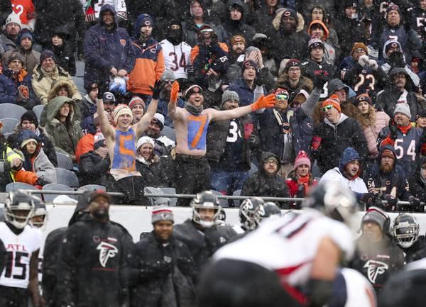 Shirtless Bears fans cheer in the fourth quarter at Soldier Field on Dec. 31, 2023.