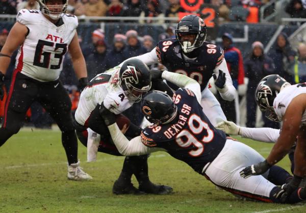 Bears defensive tackle Gervon Dexter Sr. sacks Falcons quarterback Taylor Heinicke in the fourth quarter at Soldier Field on Dec. 31, 2023.