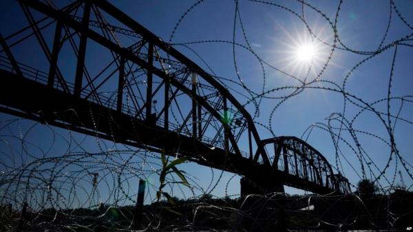 FILE - The Unio<em></em>n Pacific Internatio<em></em>nal Railroad Bridge is seen behind co<em></em>ncertina wire, Sept. 22, 2023, in Eagle Pass, Texas. 