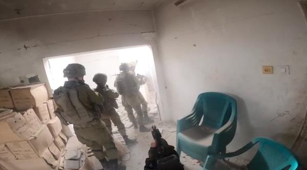 Bodycam footage shows Israeli soldiers going into a damaged building during what the Israeli army says was an operation in Khan  Younis, in the southern Gaza Strip, in this screengrab taken from a video released on December 8, 2023.
