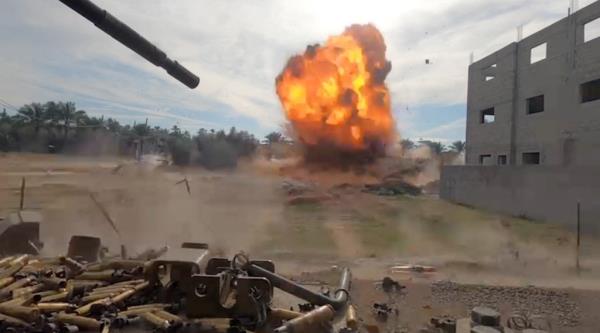 Debris scatters amidst an explosion during what the Israeli army says was an operation in Khan  Younis, in the southern Gaza Strip, in this screengrab taken from a video released on December 8, 2023.