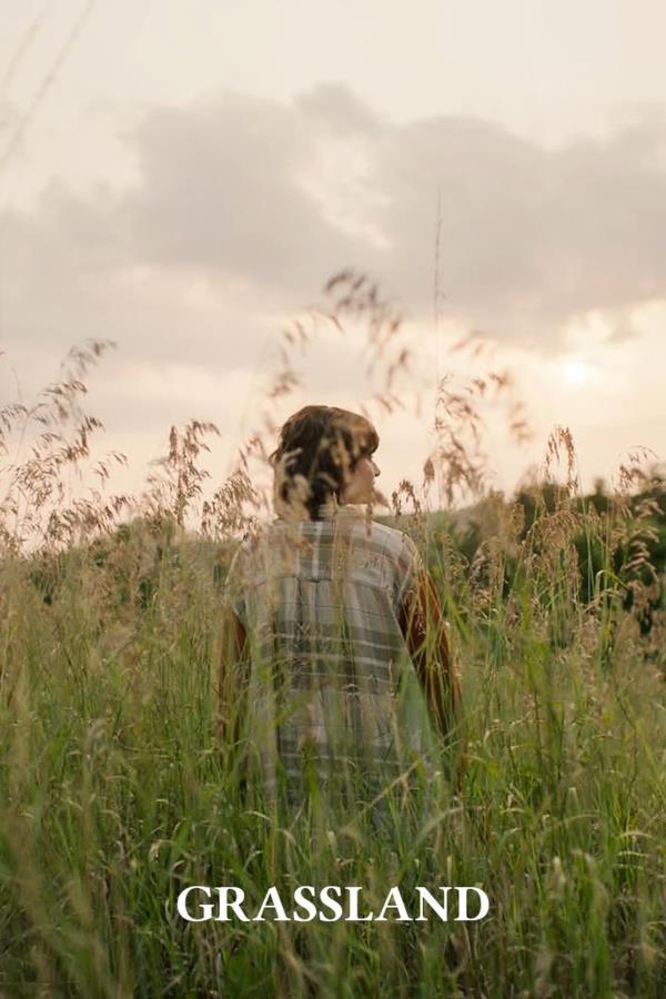 Grassland Movie Poster Showing a Young Boy Walking Through a Field