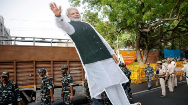 A person carries a cut-out of Indian Prime Minister Narendra Modi outside Bharatiya Janata Party (BJP) headquarters, on the day of the general election results, in New Delhi, India, June 4, 2024. REUTERS/Adnan Abidi
