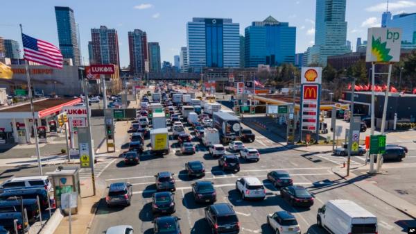 FILE - Commuters wait to drive through the Holland Tunnel into New York City in Jersey City, N.J., March 8, 2023. A study published May 22, 2024, says U.S. vehicles hit a record average age of 12.6 years in 2024.