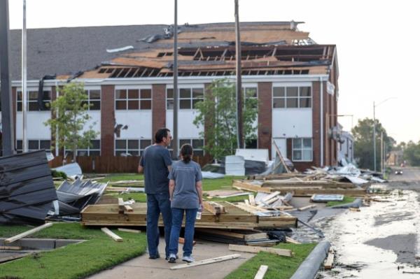 People view the damage at First Baptist Church, Sunday, May 26, 2024, in Claremore, Okla. Powerful storms left a wide trail of destruction across Texas, Oklahoma and Arkansas. (Mike Simons/Tulsa World via AP)