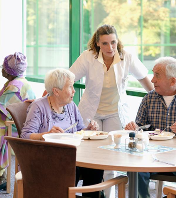 Elderly residents of a retirement village with staff.