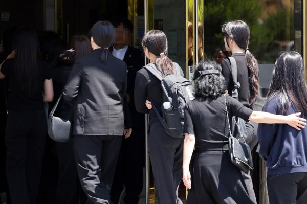 College friends of a cons<em></em>cripted soldier who died after a disciplinary drill walk into a funeral parlor in Naju, South Jeolla Province, to pay respects to the deceased on May 29. (Yonhap)
