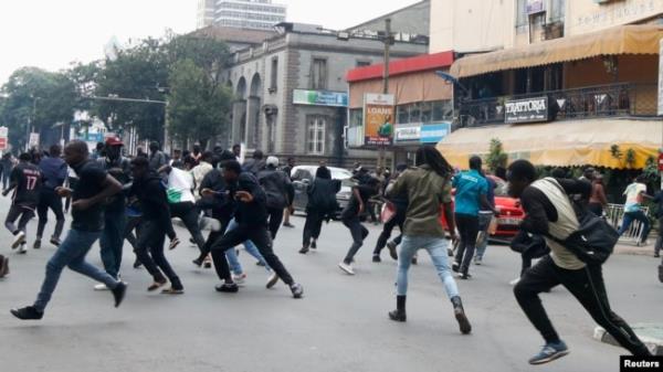 Protesters against Kenya's proposed finance bill 2024/2025 run as police officers use teargas to disperse them, in Nairobi, Kenya, June 18, 2024.