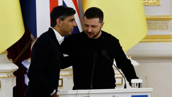 Ukrainian President Volodymyr Zelenskiy and British Prime Minister Rishi Sunak attend a security accord signing ceremony, during a visit to Presidential Palace, in Kyiv, Ukraine, January 12, 2024. REUTERS/Thomas Peter