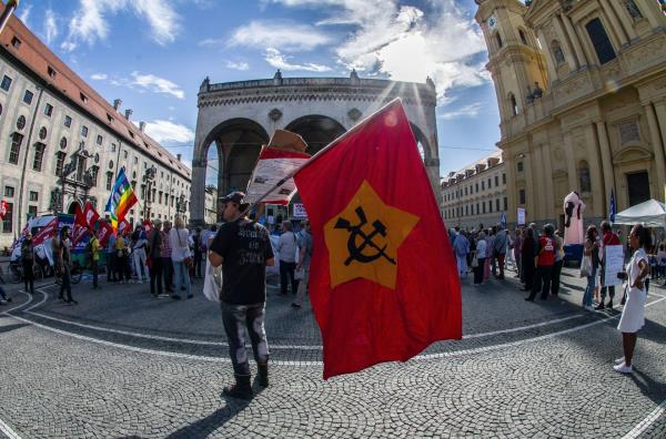 A pro-Russia supporter with a Soviet flag, demo<em></em>nstrates in Germany.