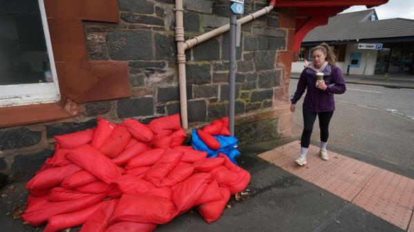 Sand bags sit piled against a wall in the main street in Aberfoyle in Perthshire. Aberfoyle was hit with flooding a couple of weeks ago as storm Babet will bring heavy rain to the UK this week, with extensive flooding expected in already-saturated parts of Scotland. The Met Office has upgraded a weather warning for rain in eastern Scotland to amber, as some areas could see more than a month's worth of rain in a few days. Picture date: Wednesday October 18, 2023.