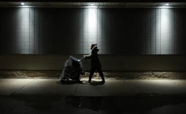 Jessica Wilson pushes a stroller holding her son, Jacobie, 2, after shopping for dinner in a gas station a<em></em>bout a half-mile from Chicago's District 3 police station on Oct. 13, 2023.