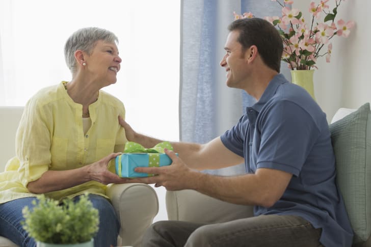 son giving his mother a mother's day gift