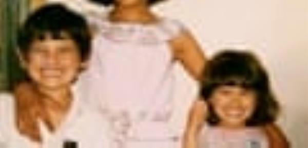 A young Tommy Nicol and Do<em></em>nna Moo<em></em>ney smiling in a family photograph.