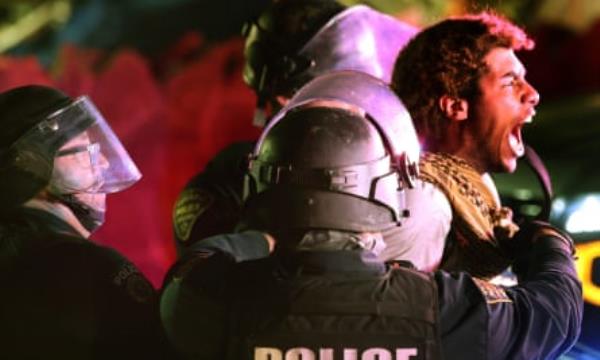 Tucson Police take a protester into custody on Park Avenue early on Wednesday.