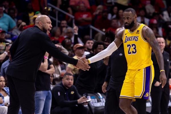 Los Angeles Lakers forward LeBron James (23) reacts after a play with  head coach Darvin Ham against the New Orleans Pelicans during the second half of a play-in game of the 2024 NBA playoffs at Smoothie King Center.  