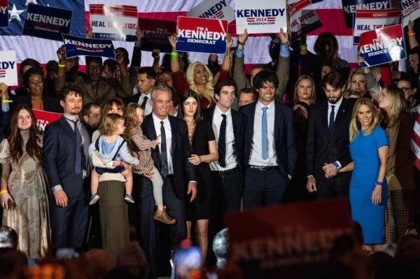 Robert F Kennedy Jr., his wife Cheryl Hines, and family members standing together at a campaign event for his 2024 presidential bid at the Boston Park Plaza