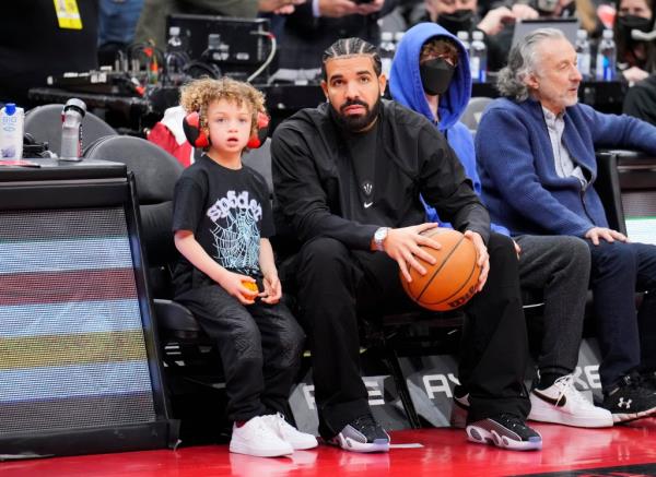 TORONTO, ON - APRIL 7: Drake sits with his son Ado<em></em>nis before the Toro<em></em>nto Raptors play the Philadelphia 76ers in their basketball game at the Scotiabank Arena on April 7, 2022 in Toronto, Ontario, Canada. NOTE TO USER: User expressly acknowledges and agrees that, by downloading and/or using this Photograph, user is co<em></em>nsenting to the terms and co<em></em>nditions of the Getty Images License Agreement. (Photo by Mark Blinch/Getty Images)