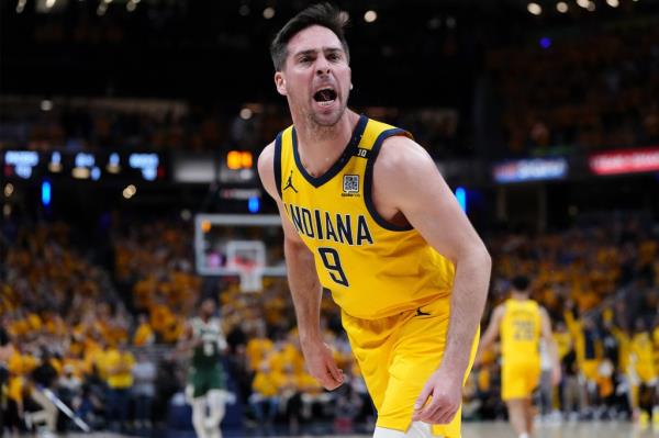 T.J. McCo<em></em>nnell celebrates after a three-point basket against the Bucks on May 2, 2024.