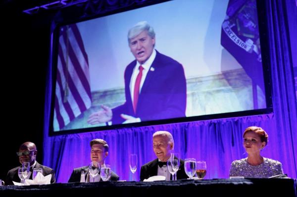 Biden and Jost watch a skit of SNL's James Austin Johnson protraying Do<em></em>nald Trump during the White House Correspondent's Association Dinner on Saturday.