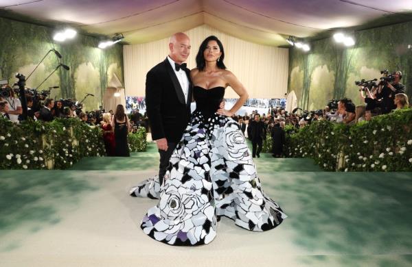 Jeff Bezos and Lauren Sanchez posing on the red carpet at the 2024 Met Gala, themed 'Sleeping Beauties: Reawakening Fashion', at The Metropolitan Museum of Art in New York