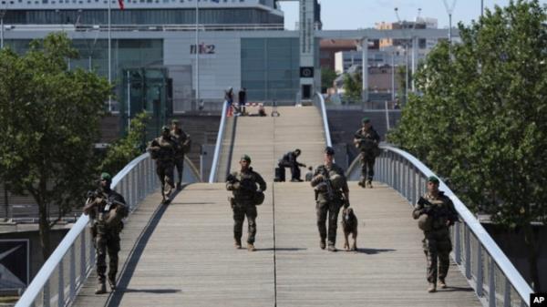 Soldiers patrol on a footbridge over the Seine River in Paris, July 17, 2024.