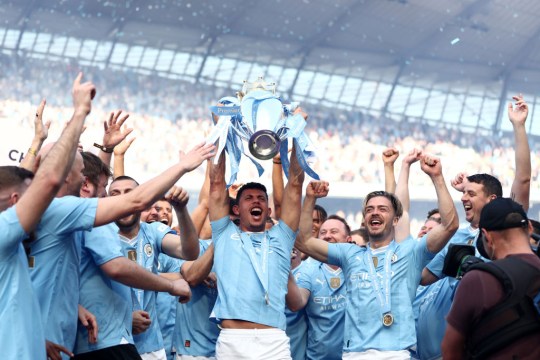 Matheus Nunes of Manchester City lifts the Premier League trophy after their win over West Ham
