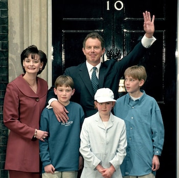 Tony Blair waving outside No 10 Downing St, with his wife and three children grouped tightly around him