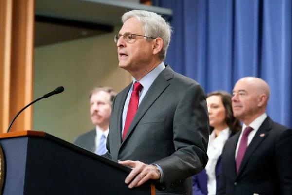 Attorney General Merrick Garland speaks with reporters during a news co<em></em>nference at the Department of Justice, on Dec. 6, 2023, in Washington, as Secretary of Homeland Security Alejandro Mayorkas, right, looks on. 