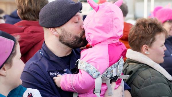 Petty Officer Nicholas Baker holds his daughter Amelia-Rose after the Royal Navy aircraft carrier HMS Prince of Wales returns to Portsmouth Naval ba<em></em>se following it's three-mo<em></em>nth deployment to the Eastern Seaboard of the United States, wher<em></em>e the Prince of Wales has been undergoing trials and operating with aircraft and drones. Picture date: Mo<em></em>nday December 11, 2023. PA Photo. See PA story DEFENCE Carrier. Photo credit should read: Andrew Matthews/PA Wire