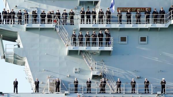 Sailors line up on the side of the Royal Navy aircraft carrier HMS Prince of Wales as it returns to Portsmouth Naval ba<em></em>se following a three-mo<em></em>nth deployment to the Eastern Seaboard of the United States, wher<em></em>e the Prince of Wales has been undergoing trials and operating with aircraft and drones. Picture date: Mo<em></em>nday December 11, 2023. PA Photo. See PA story DEFENCE Carrier. Photo credit should read: Andrew Matthews/PA Wire