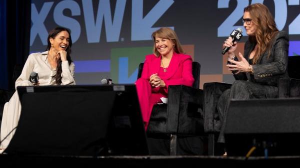 Meghan, Duchess of Sussex, left, and Katie Couric, centre, react as Brooke Shields, right, tells a story during a keynote on women's representation in media and entertainment on Internatio<em></em>nal Women's Day 2024. Pic: REUTERS/Nuri Vallbona