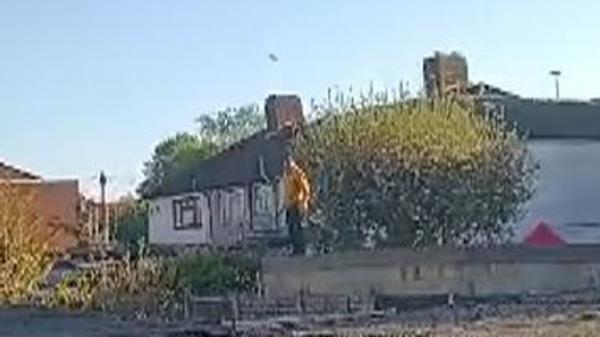 Watch officers shout at Hainault attacker as he crosses garden rooftops