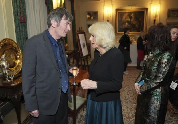 Two people talk with one another during a reception.