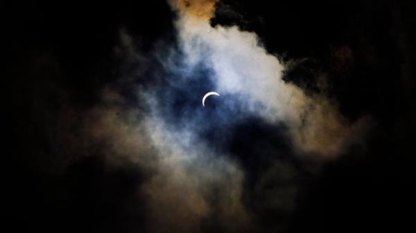 Clouds cover the sky prior to a total solar eclipse, Monday, April 8, 2024, in Arlington, Texas. (AP Photo/Julio Cortez)