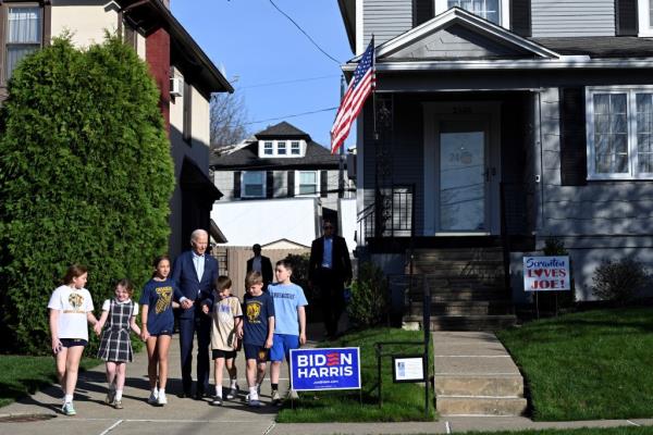 President Joe Biden walks with children in front of his childhood home in Scranton, Pennsylvania, on April 16, 2024. 