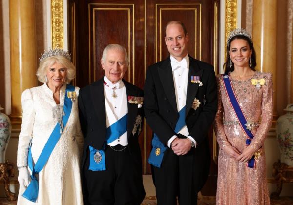 King Charles III, Queen Camilla, Prince William, and Catherine posing for a photograph at The Diplomatic Reception in Buckingham Palace
