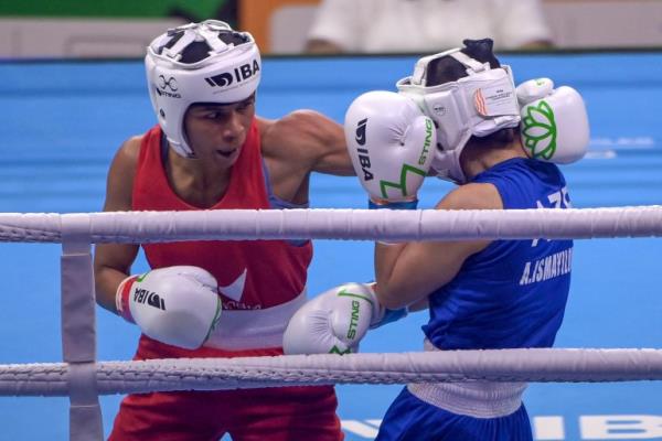 Nikhat Zareen throws punch in boxing ring.
