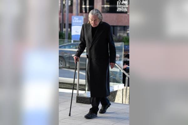 A picture of Ozzy Osbourne walking into a medical center.