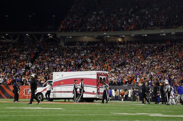 Fans look on as the ambulance leaves carrying Bills safety Damar Hamlin after he suffered cardiac arrest on the field against the  Bengals at Paycor Stadium on Jan. 2, 2023 in Cincinnati, Ohio.  