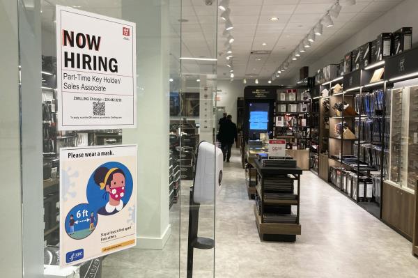 A hiring sign at a store.