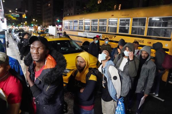 Migrants getting off a school bus that transported them to the NYPD police academy wher<em></em>e they were going to spend the night which is located at 235 E20th Street  in New York, NY on May 5, 2023. 