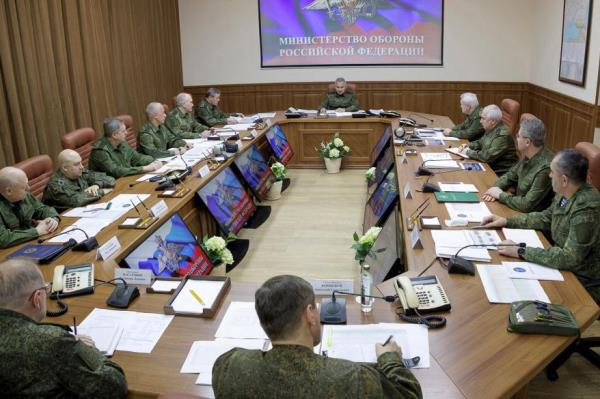 Russian Defense Minister Sergei Shoigu, background center, speaks during a meeting with Russian top level officers.
