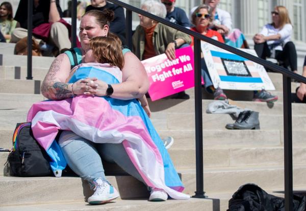 Dr. Candice Moran embraces her child Carter Moran, 7, during a protest for transgender rights Wednesday, March 29, 2023, outside the Missouri State Capitol in Jefferson City. 